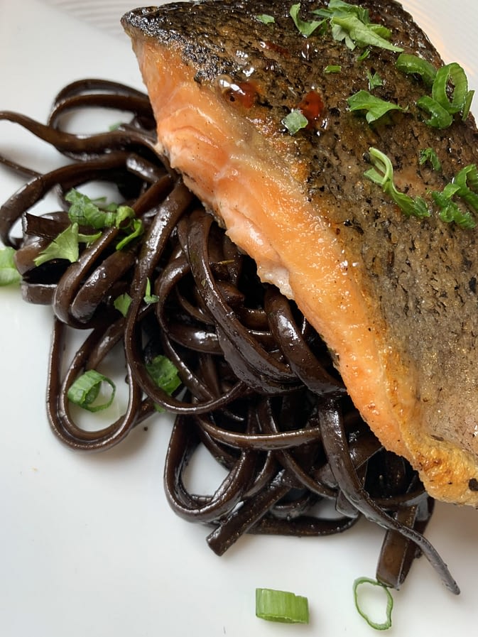 Salmon over black noodles by Chef Jeff Morneau