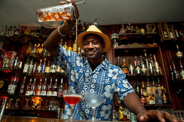 Ian Burrell, co-founder of Equiano Rum pouring a drink